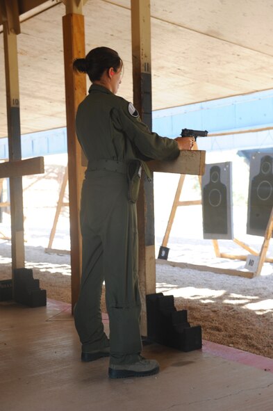 Capt. Kristina Ellis, 9th Bomb Squadron, fires down range during an M-9 qualification course, Oct. 5, 2011, at Dyess Air Force Base, Texas. In order for an individual to qualify, a minimum of 35 out of 50 shots must hit the target. (U.S. Air Force photo by Airman 1st Class Cierra Bullock/Released) 
