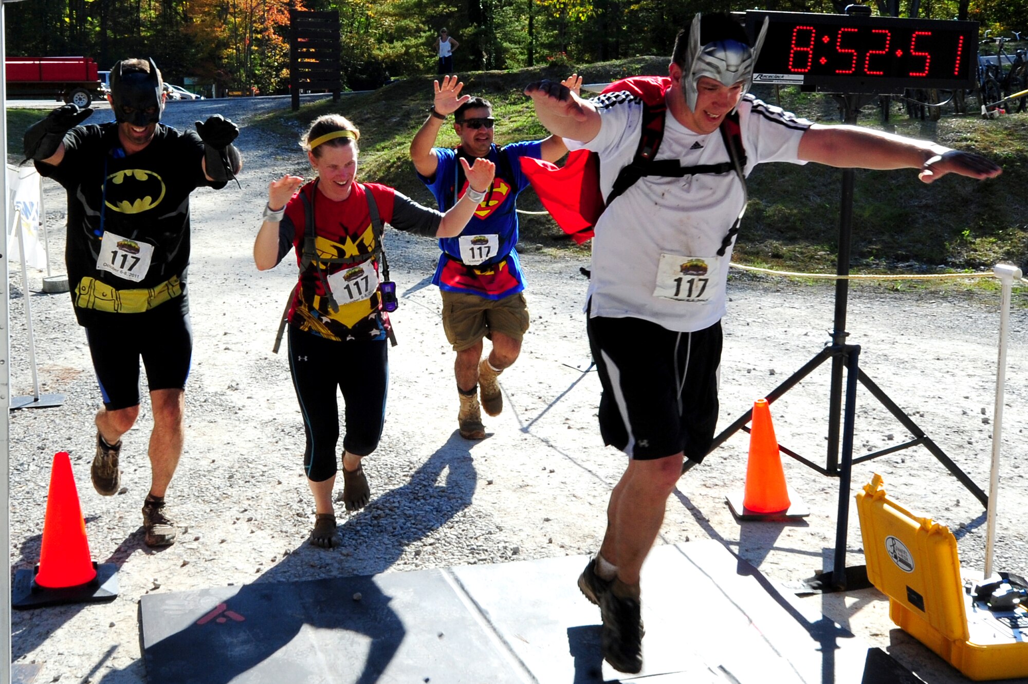 Members of Team America Global Police cross the finish line after completing the 11th Annual Wilderness Challenge in Fayetteville W. Va., October 8, 2011. A total of 29 teams competed in the five-event challenge that covered 52-miles of land. (U.S. Air Force photo by Airman 1st Class Kayla Newman/Released)