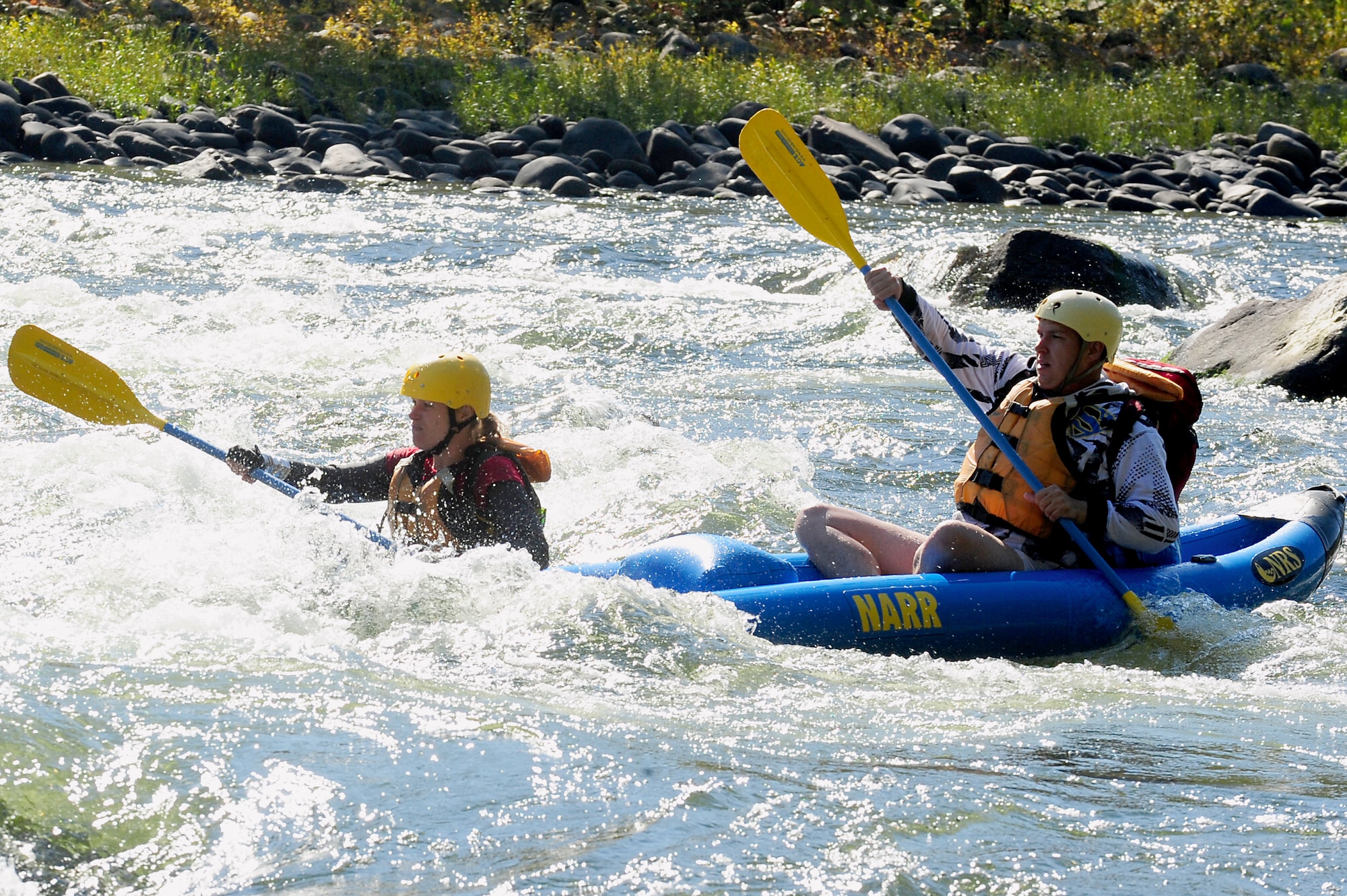 U.S. Army Staff Sgt. Kimberly Brandmeyer and Sgt. 1st Class Steven Burge, members of Team America Global Police, steer through the New River for seven miles in a “duckie” as part of the 2011 Wilderness Challenge in Fayetteville W. Va., October 8, 2011. A “duckie” is a combination of a raft, canoe and kayak with double edge paddles used for maneuvering. (U.S. Air Force photo by Airman 1st Class Kayla Newman/Released)