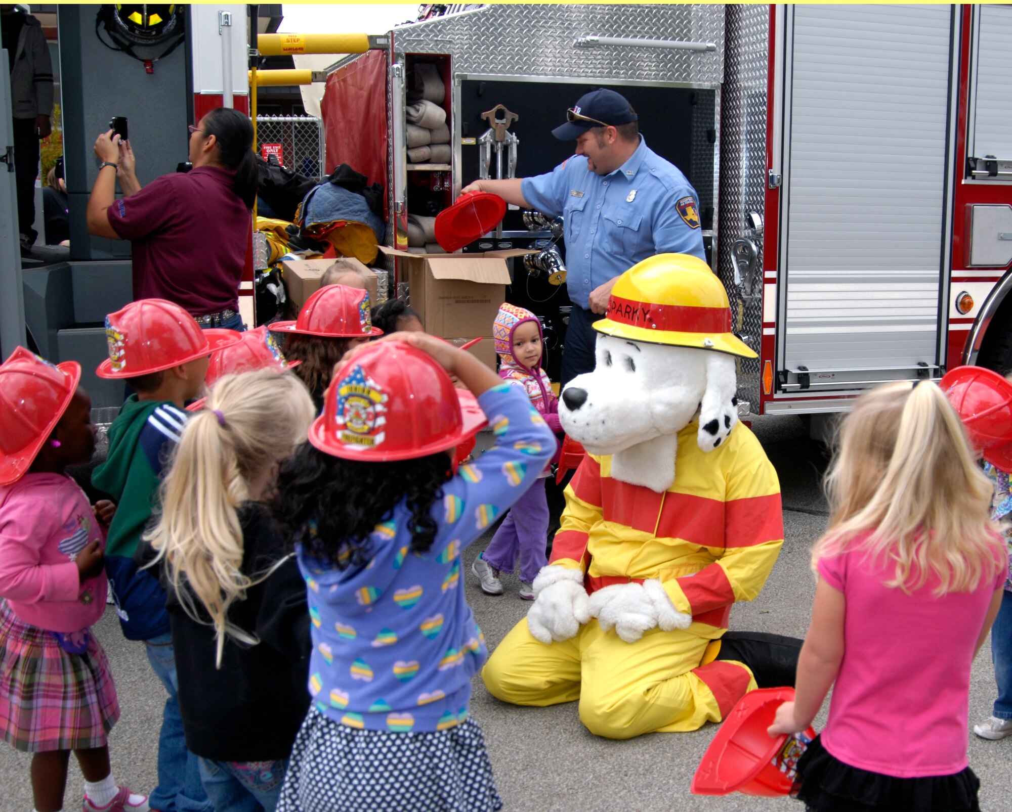 GOODFELLOW AIR FORCE BASE, Texas – Sparky the firedog plays with children during a fire prevention awareness event at the Child Development Center here Oct. 11. Members from Goodfellow’s Fire Department visited the CDC as part of 89th National Fire Prevention Week. The children got to play with Sparky, explore a fire truck and become familiar with firefighters during the visit. (U.S. Air Force photo /Senior Airman Heather L. Rodgers)