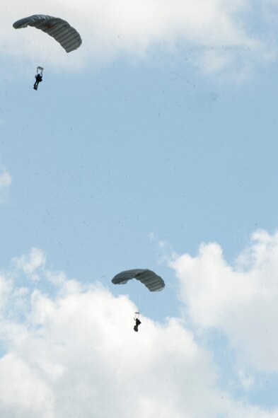 U.S. Air Force pararescuemen from the 38th Rescue Squadron float  to a landing zone after jumping from an HC-130P Combat King to kick off Spouse Orientation Day Oct. 7, 2011, at Moody Air Force Base, Ga. The jump allowed family members of the 38th RQS to witness their military counterparts in action. Spouse Orientation Day is held annually, and usually during a deployment cycle, allowing spouses to come together as they learn about their military member's career. (U.S. Air Force photo by Staff Sgt. Joshua J. Garcia/Released)  