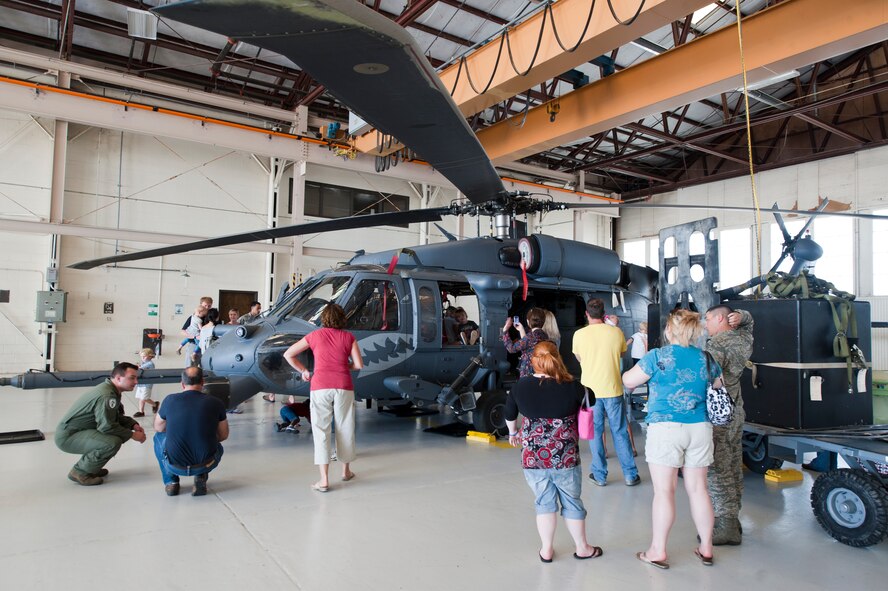 Family members of the 38th Rescue Squadron get a tour of an HH-60G Pave Hawk during Spouse Orientation Day at Moody Air Force Base, Ga., Oct. 7, 2011. The tour was one of the many attractions the 38th RQS provided to showcase the work of its personnel. (U.S. Air Force photo by Staff Sgt. Joshua J. Garcia/Released)