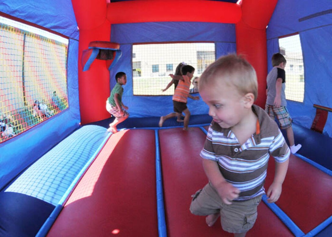 A young family member plays on the "moonwalk" during the 147th Reconnaissance WIng Family Day at Ellington Field Joint Reserve Base, Houston. Family Day is held once a year to recognize and honor our family members.