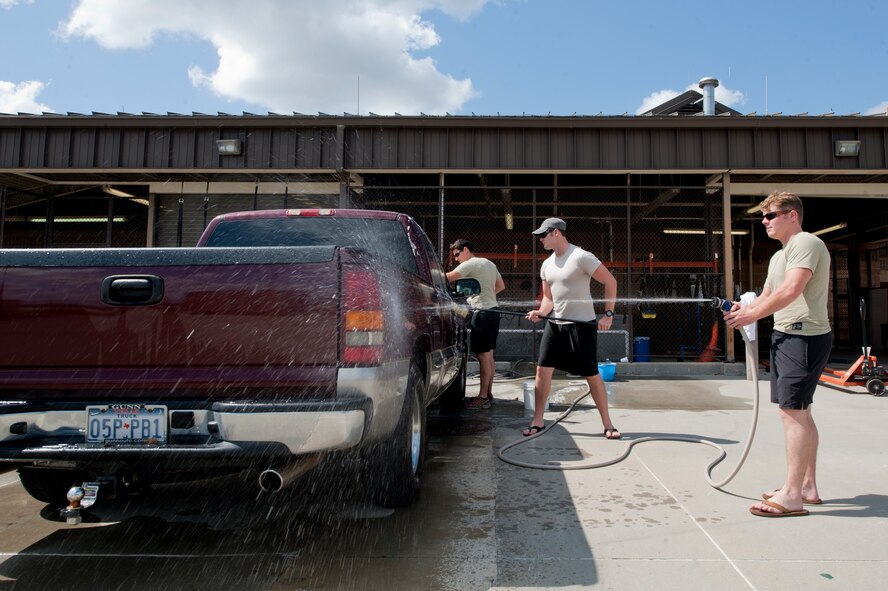 Members of the 38th Rescue Squadron wash a truck for a deployed member’s spouse Oct. 7, 2011, for Spouse Orientation Day at Moody Air Force Base, Ga. The car wash was one of the services the 38th RQS offered to its deployed members’ families. Spouse Orientation Day highlighted the work environment of the 38th RQS and allowed the squadron to reach out to deployed members’ families to inform them of squadron support, regardless of their spouse deployment status. (U.S. Air Force photo by Staff Sgt. Joshua J. Garcia/Released) 