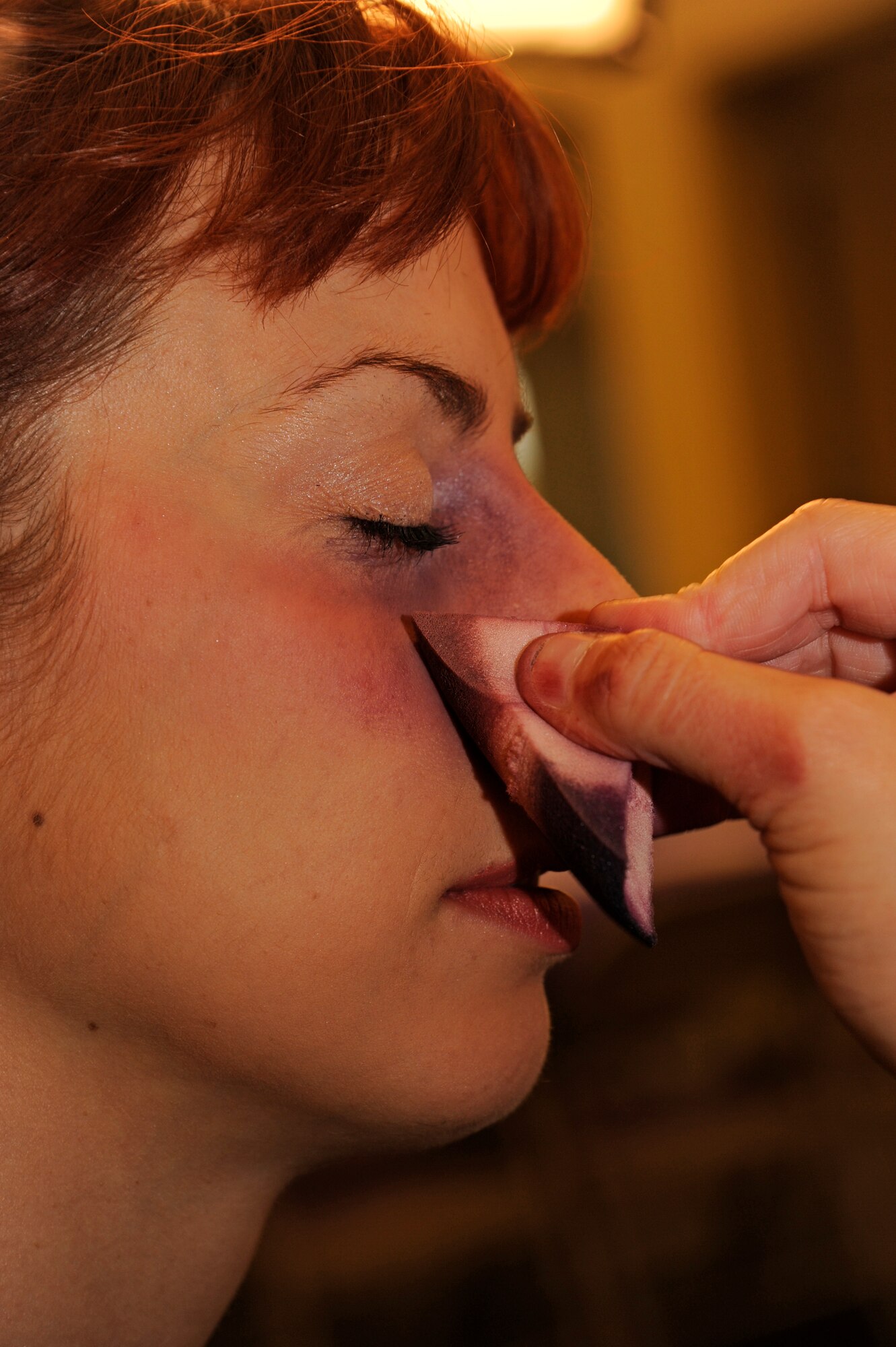 VANDENBERG AIR FORCE BASE, Calif. - Staff Sgt. Sarah Byelick, a 2nd Range Operations Squadron member, receives a simulated black eye during a Black Eye Campaign at the Balfour Beatty Community Center here Thursday, Oct. 6, 2011. Several members of Team Vandenberg simulated having a black eye to raise awareness about domestic violence. The goal of the campaign is to educate the community on how to help victims of domestic abuse and to share resources available to the victims.  (U.S. Air Force photo/Senior Airman Lael Huss)
