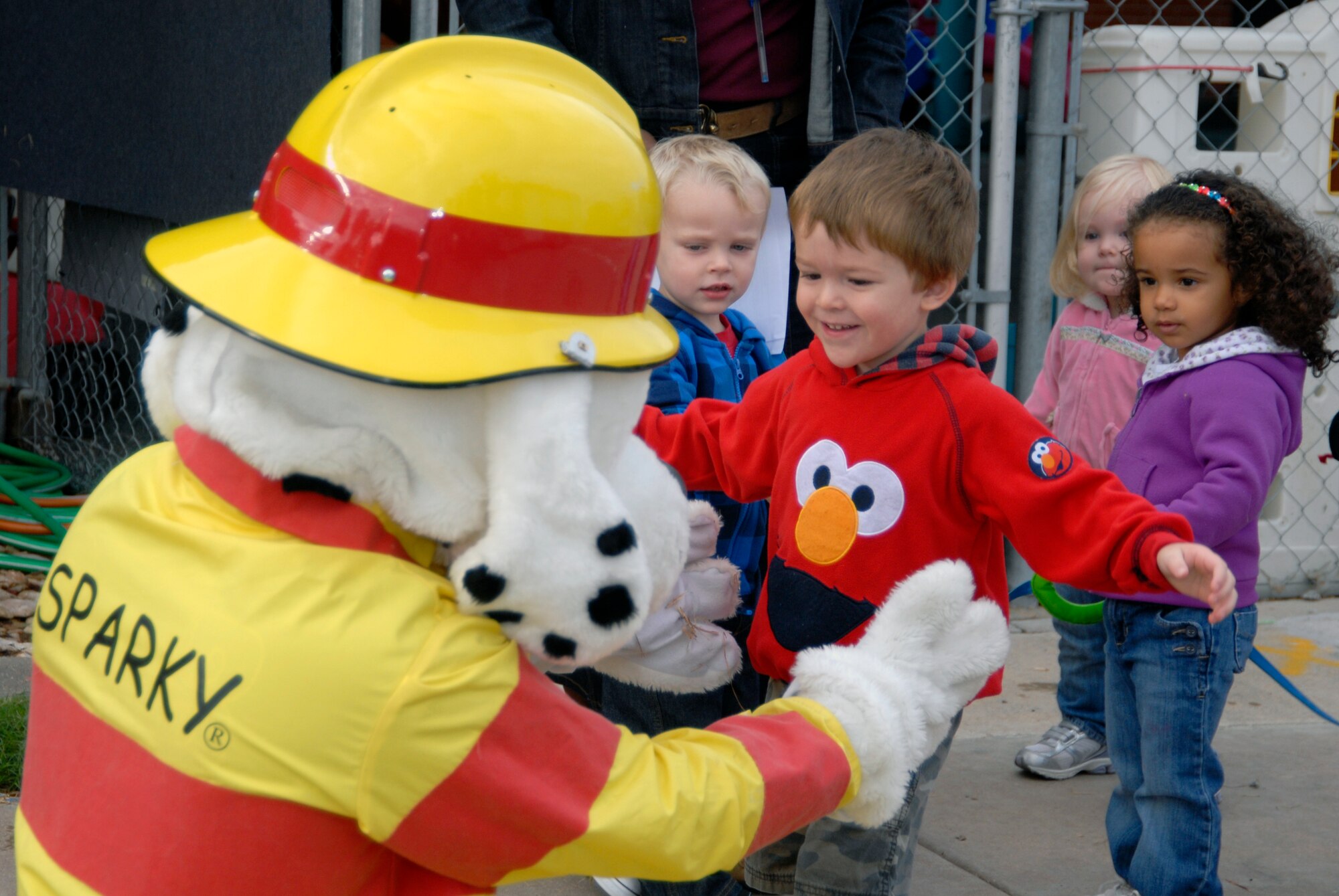 GOODFELLOW AIR FORCE BASE, Texas – Garrett Hughes greets Sparky the firedog with a hug during a fire prevention awareness event at the Child Development Center here Oct. 11. Members from Goodfellow’s Fire Department visited the CDC as part of the 89th National Fire Prevention Week. The children got to play with Sparky, explore a fire truck and become familiar with firefighters during the visit. (U.S. Air Force photo /Senior Airman Heather L. Rodgers)