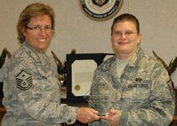 Master Sgt.Tricia Miller of the 919th Special Operations Wing Judge Advocate General's office, right, receives October's Sharp Airman award from Master Sgt. Julie Palmer of the 919th SOW's First Sergeants Council.  Each month the council recognizes one or more deserving individuals for their efforts that reflect positively upon the Air Force and reinforce its wingman culture.  (U.S. Air Force photo/Staff Sgt. Jennifer Babb)
 
