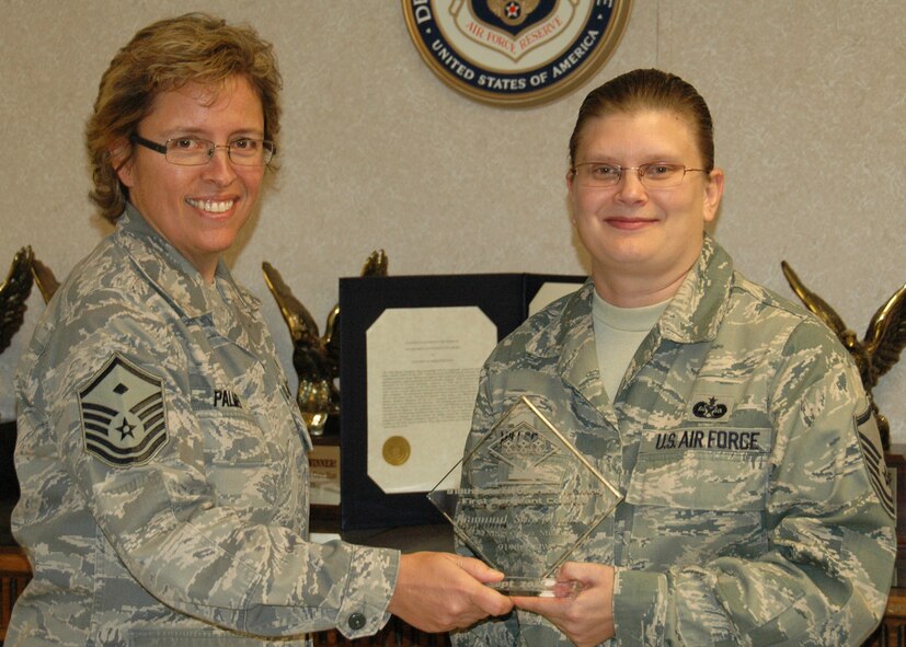 Master Sgt.Tricia Miller of the 919th Special Operations Wing Judge Advocate General's office, right, receives October's Sharp Airman award from Master Sgt. Julie Palmer of the 919th SOW's First Sergeants Council.  Each month the council recognizes one or more deserving individuals for their efforts that reflect positively upon the Air Force and reinforce its wingman culture.  (U.S. Air Force photo/Staff Sgt. Jennifer Babb)
 
