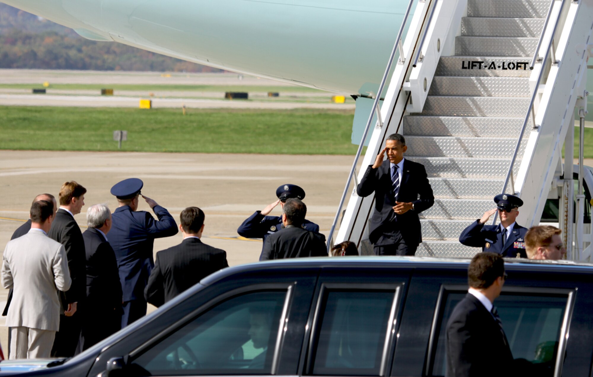 Col. James B. Finney, 911th Airlift Wing commander (bottom left) renders honors to the Commander-In-Chief, President Barack Obama (center), Oct. 11, 2011.  The president arrived midmorning at the 911th Airlfit Wing in Moon Twp. and after greeting members of the official party, the President walked away from the motorcade and shook hands with several Airmen from the base and a few of his invited guests.  President Obama then departed for a tour of IBEW facilities on the South Side of Pittsburgh and then he convened a meeting of the Council on Jobs and competitiveness. (U.S. Air Force Photo/By Capt. Shawn M. Walleck),