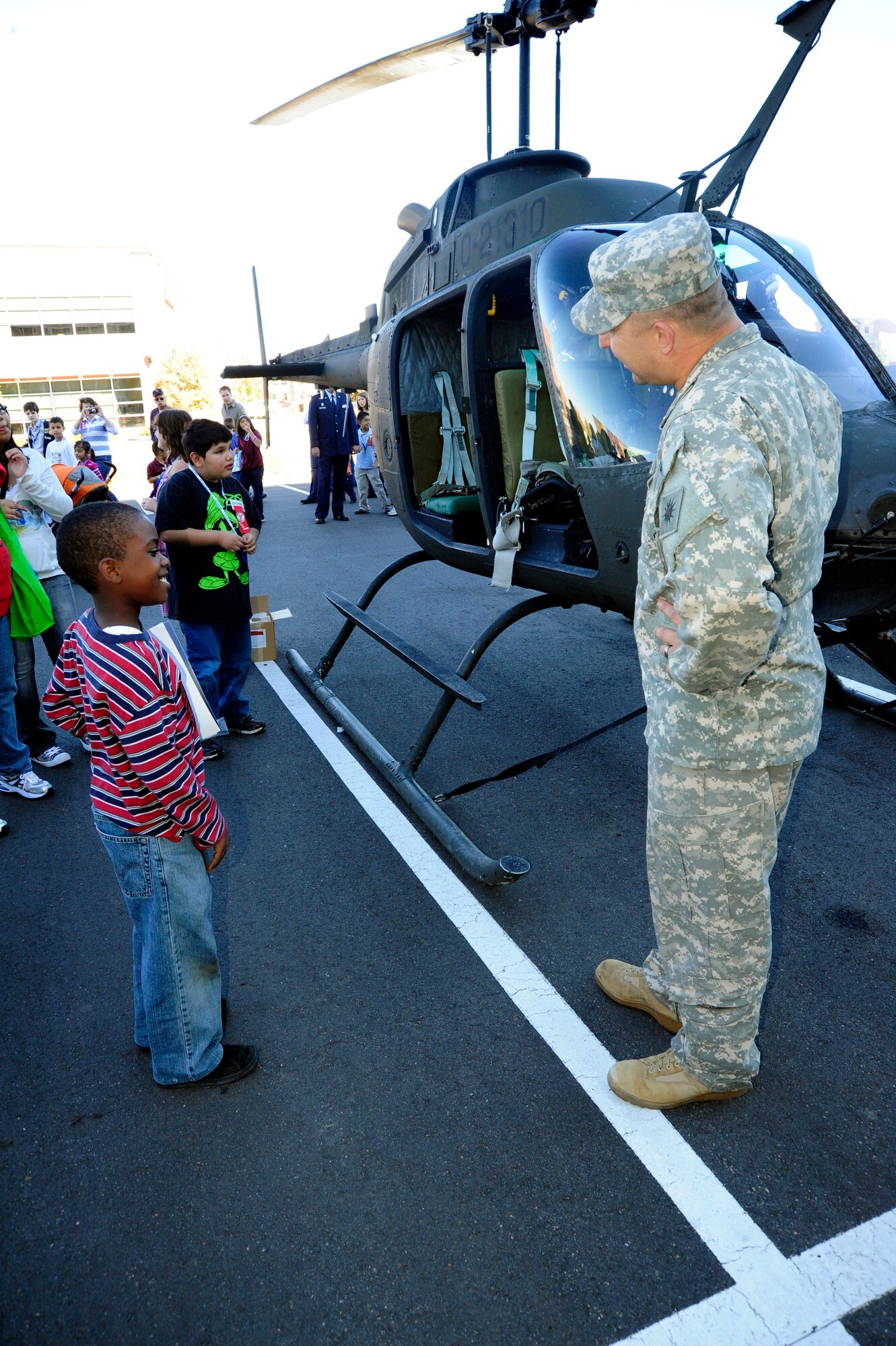 Elementary school children speak with a Soldier and get a close-up view of a Colorado National Guard OH-58 Kiowa helicopter at a Red Ribbon Week event in 2009. (U.S. Air Force photo by Staff Sgt. Nicole Manzanares, Colorado Air National Guard) 
