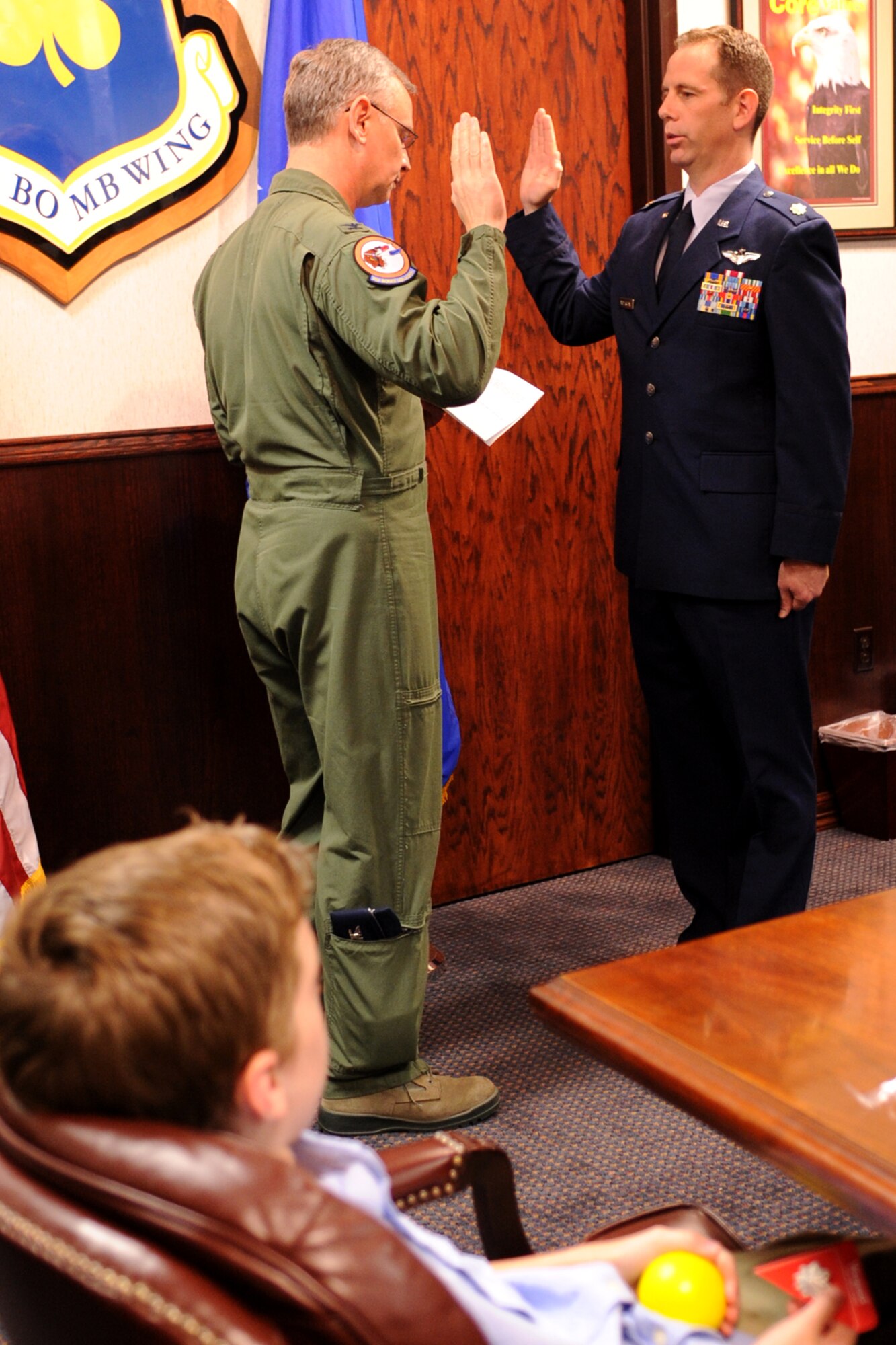 Callum Anderson watches as his dad, U.S. Air Force Lt. Col (S) Chris Anderson, recites the oath from Col. Joseph Jones, 307th Bomb Wing vice commander, during his pinning-on ceremony at Barksdale Air Force Base, La., Oct. 7, 2011. Anderson is a B-52 radar navigator and Chief of Weapons Training for the 93rd Bomb Squadron, 307th Bomb Wing. (U.S. Air Force photo by Master Sgt. Greg Steele/Released)