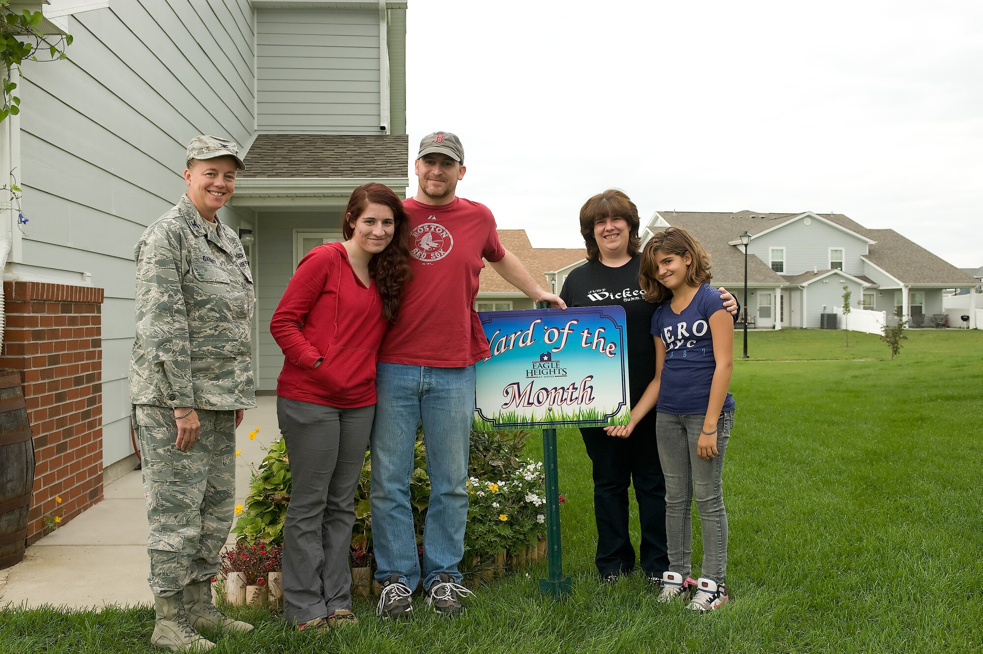 Col. Joan Garbutt (left), commander of the 436th Mission Support Group, stands with Master Sgt. David Smith, his wife Penny and their two children Kacie and McKenna, recognizing the Smith family as the Blue Heron Breeze Yard of the Month winners for September at Dover Air Force Base, Del. (U.S. Air Force photo by Steve Kotecki)