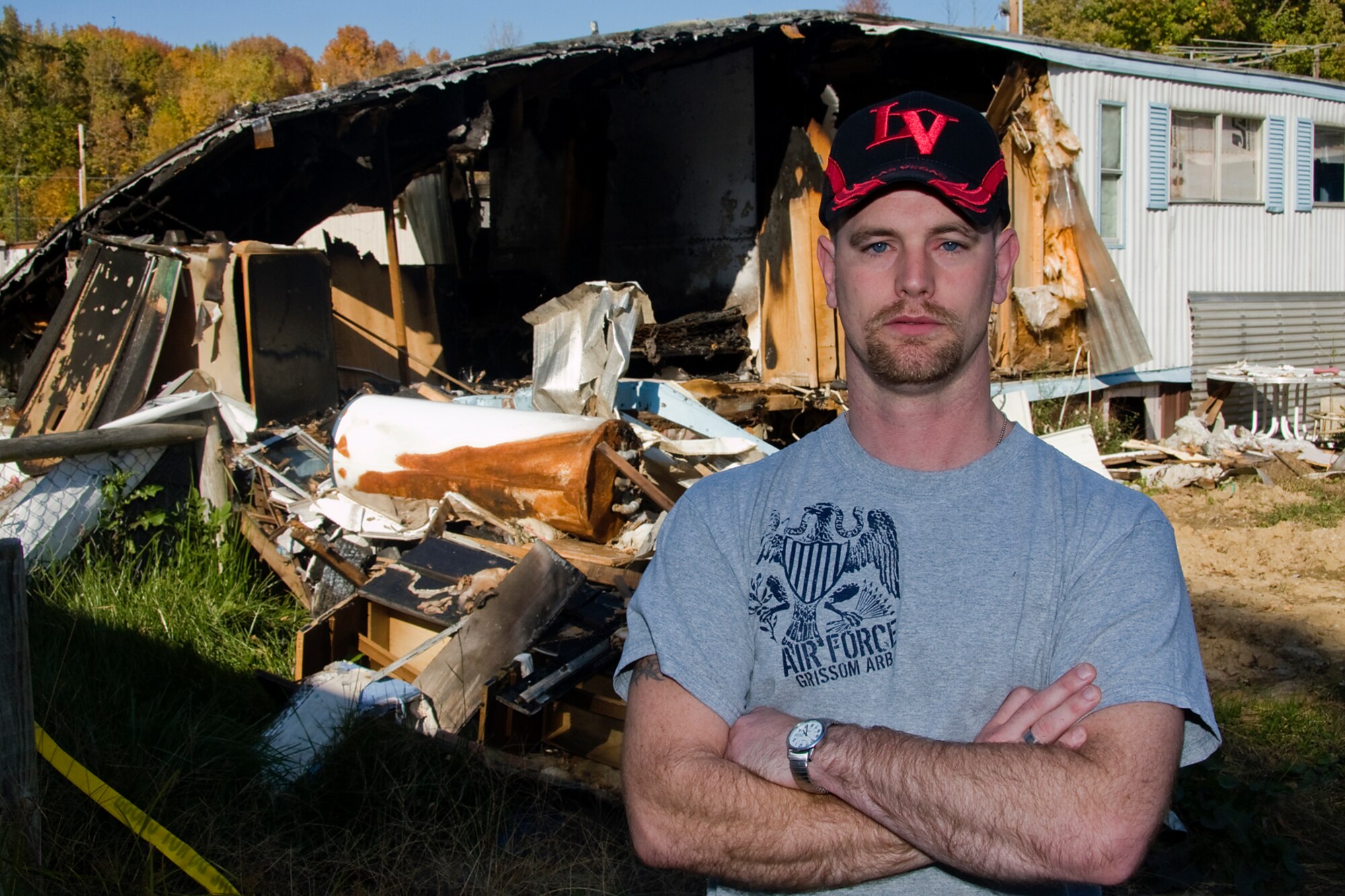 GRISSOM AIR RESERVE BASE, Ind. -- Tech. Sgt. Damon Spradlin, 434th Aerospace Medicine Squadron bioenvironmental engineering craftsman, stands in front of a mobile home that was recently engulfed by a fire. Spradlin ran into the home and saved the life of a dog trapped in the fire. (U.S. Air Force photo/Tech. Sgt. Mark R. W. Orders-Woempner)
