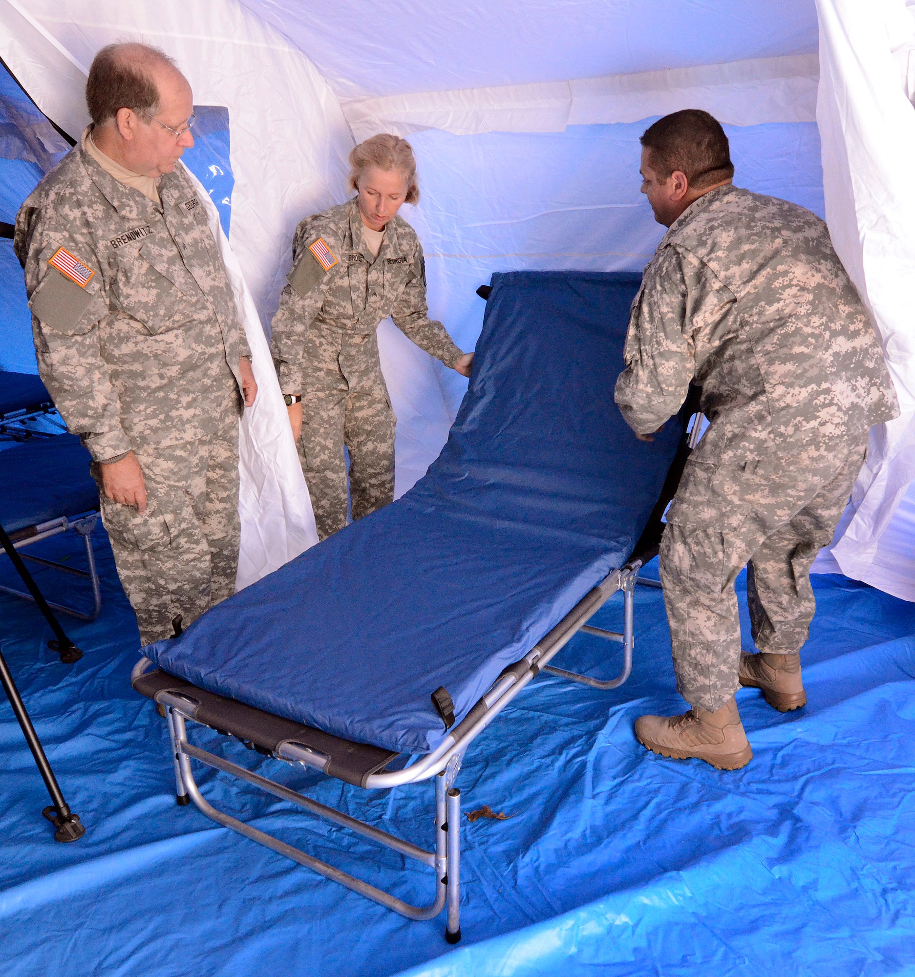 Members of the Georgia State Defense Force set up a portable patient bed during a mass casualty exercise at Dobbins Air Reserve Base, Oct. 8. The Cobb & Douglas Public Health office ran the mass casualty exercise using their Mobile Surge Unit to help prepare local civilian medical personnel for a mass casualty event.   (U.S. Air Force photo/ Brad Fallin)