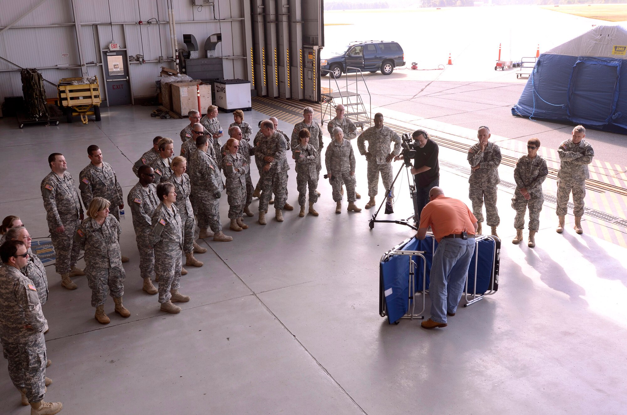 Skip Stephenson, sales representative for EMS Innovations Inc., briefs members of the Georgia State Defense Force on how to set up portable patient beds during a mass casualty exercise at Dobbins Air Reserve Base, Oct. 8. The Cobb & Douglas Public Health office ran the mass casualty exercise using their Mobile Surge Unit to help prepare local civilian medical personnel for a mass casualty event.   (U.S. Air Force photo/ Brad Fallin)