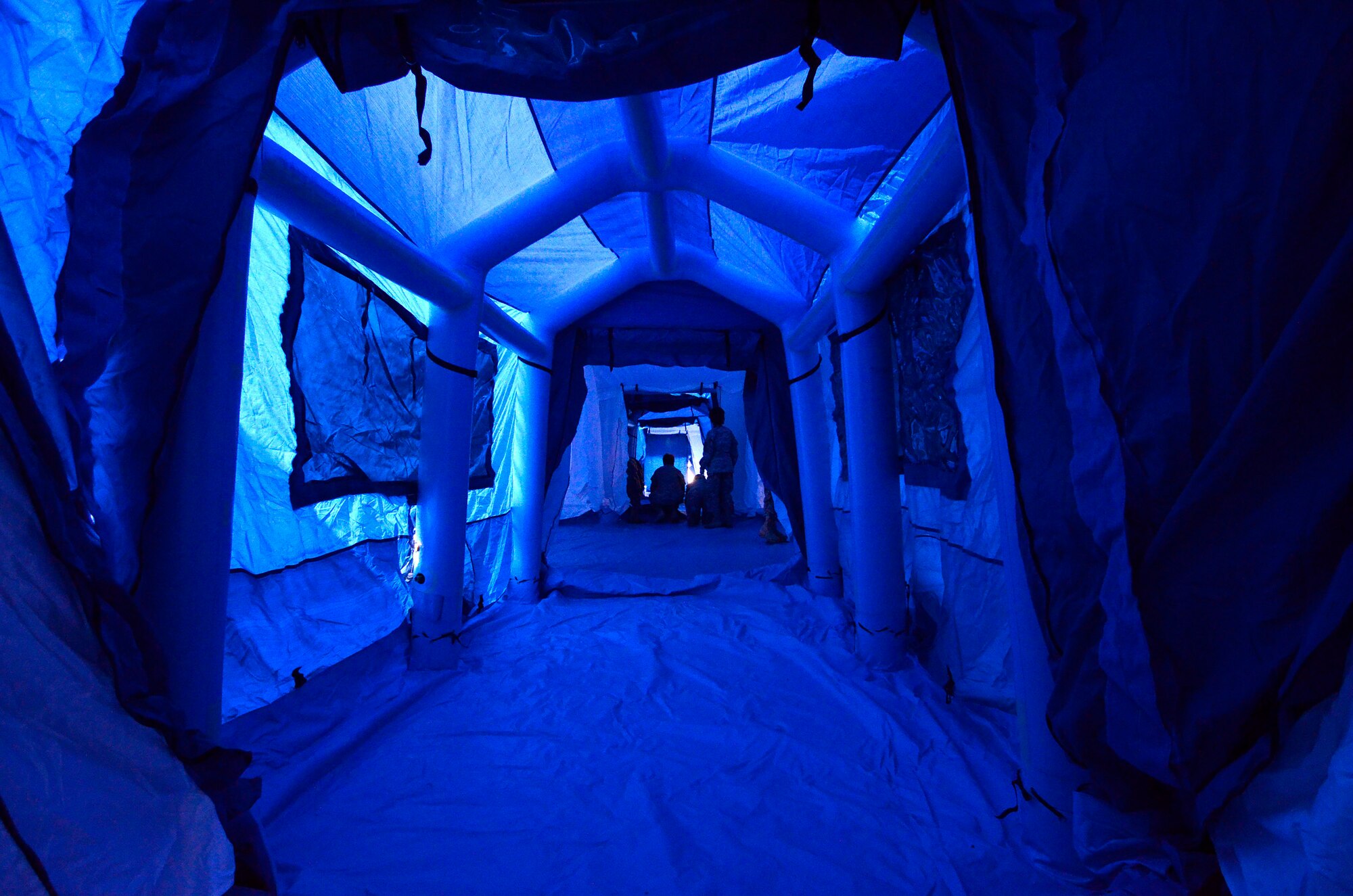 Looking down one of the passageways that connect the six units of the 50 bed mobile medical surge unit used during a mass casualty exercise at Dobbins Air Reserve Base, Oct. 8. The Cobb & Douglas Public Health office ran the mass casualty exercise using their Mobile Surge Unit to help prepare local civilian medical personnel for a mass casualty event.   (U.S. Air Force photo/ Brad Fallin)
