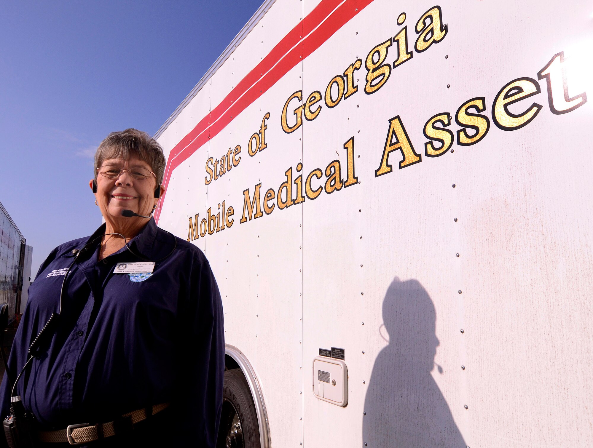 Pam Blackwell, director of emergency preparedness for Cobb & Douglas Public Health Department, stands-by one of the trailers used to transport the 50 bed mobile medical surge unit utilized during a mass casualty exercise at Dobbins Air Reserve Base, Oct. 8. The Cobb & Douglas Public Health office ran the mass casualty exercise to help prepare local civilian medical personnel for a mass casualty event.   (U.S. Air Force photo/ Brad Fallin)