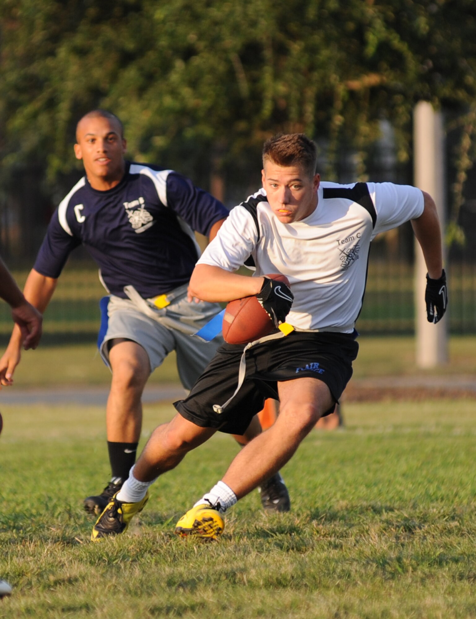 Sivad Pope, left, 338th Training Squadron-B team, is hot on the trail of Zachary Taylor, 338th TRS-C team, who runs across the field looking for an opening during a National Conference intramural flag football team Oct. 6 at Keesler Air Force Base, Miss. The 338th TRS-C posted a 12-6 victory.  (U.S. Air Force photo by Kemberly Groue)