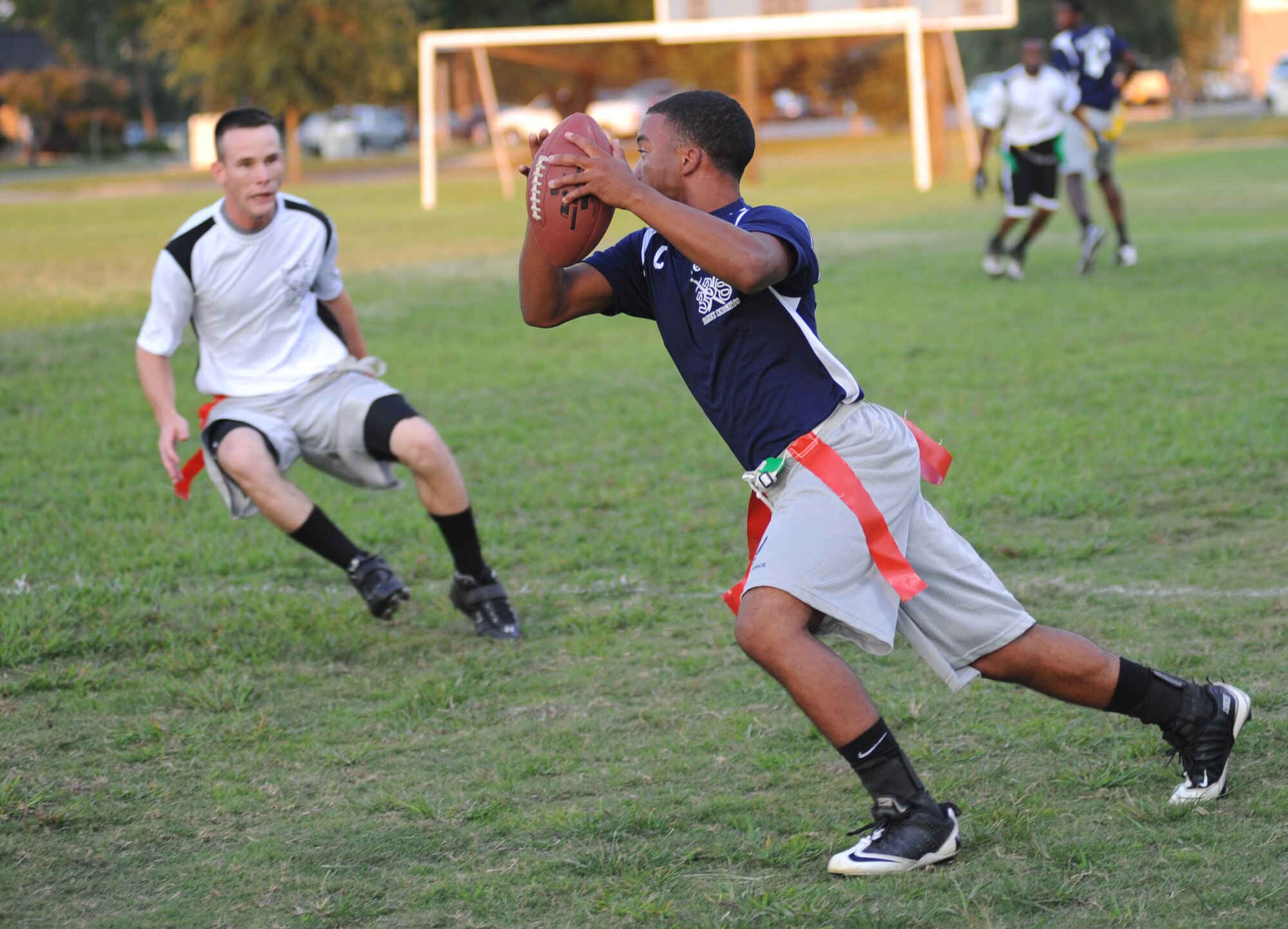 Samuel Davis, 338th Training Squadron-C team, goes on the defense as Aaron Brandon, 338th TRS-B team, catches a pass and heads toward the end zone during a National Conference intramural flag football team Oct. 6 at Keesler Air Force Base, Miss.  The 338th TRS-C posted a 12-6 victory.  (U.S. Air Force photo by Kemberly Groue)