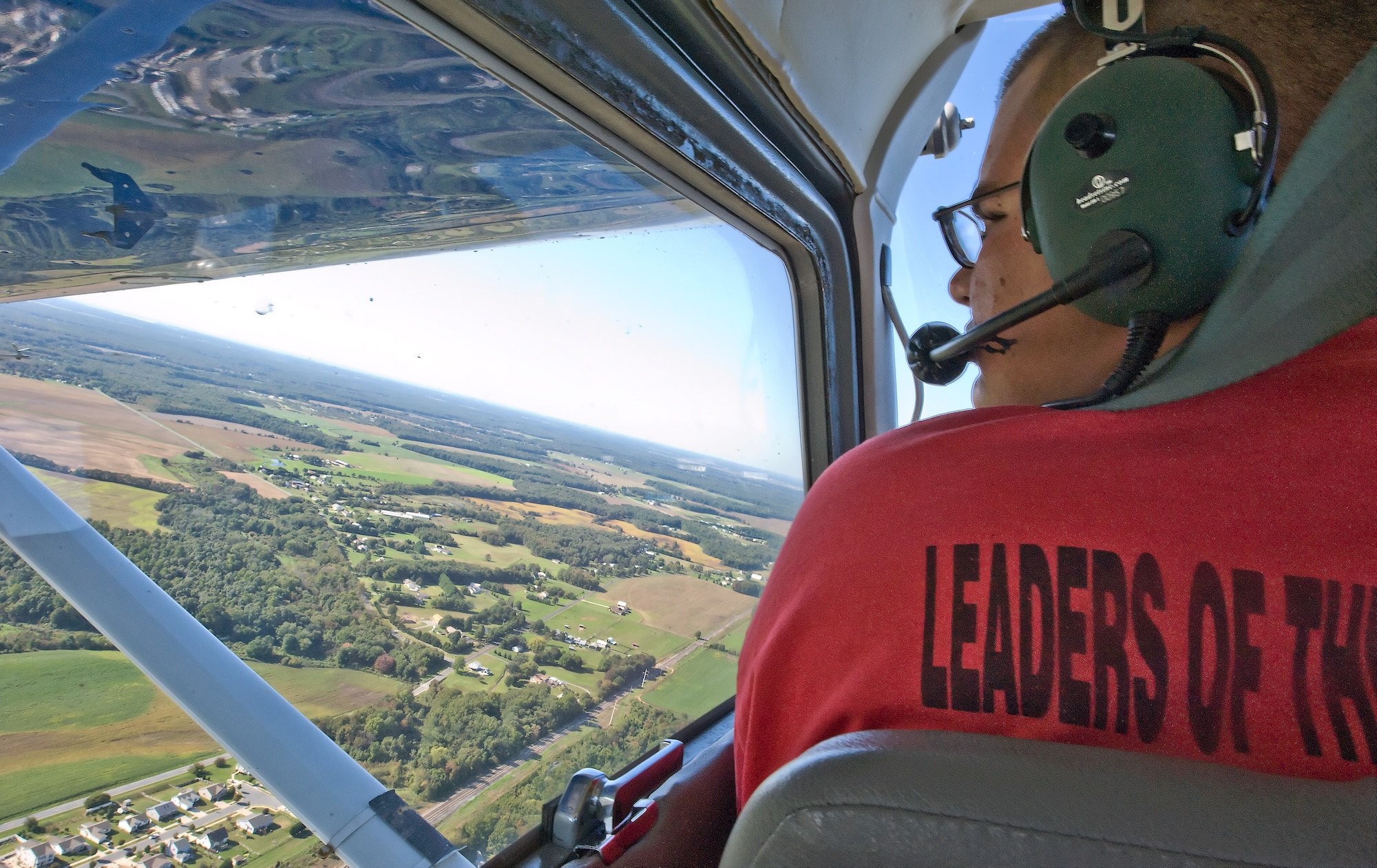 Cody Scheers, a student of the 436th Force Support Squadron Aero Club, looks out on Dover, Del., during a flight lesson Oct. 6, 2011. Scheers is one of many students working towards their private pilot’s license at the aero club. (U.S. Air Force photo by Airman 1st Class Samuel Taylor)