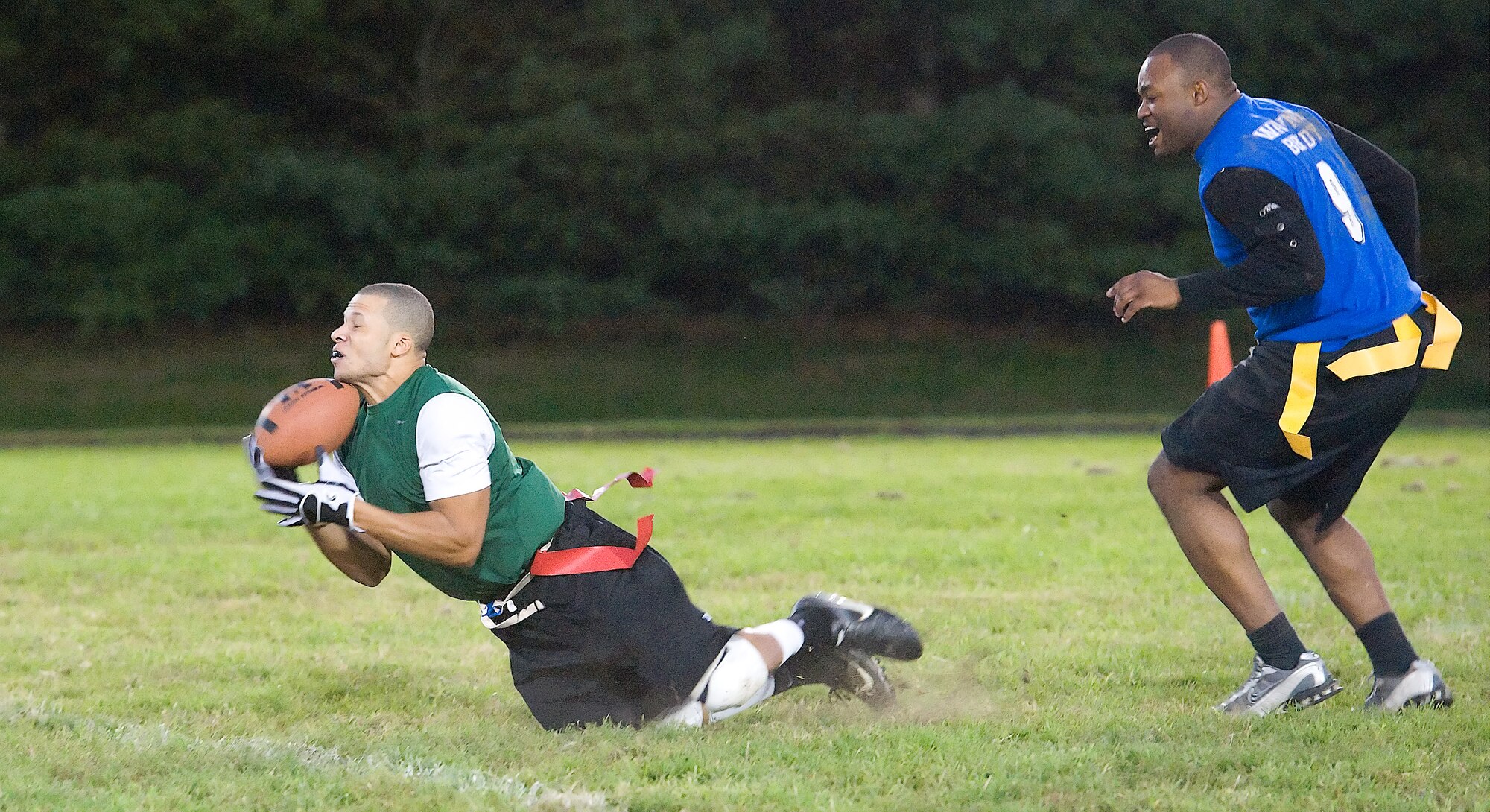Kevin Flowers (left) makes a diving catch in front of Gregory Henry Oct. 6, 2011, at Dover Air Force Base, Del. The 736th Aircraft Maintenance Squadron defeated the 436th Communications Squadron 42-21. (U.S. Air Force photo by Airman 1st Class Samuel Taylor)