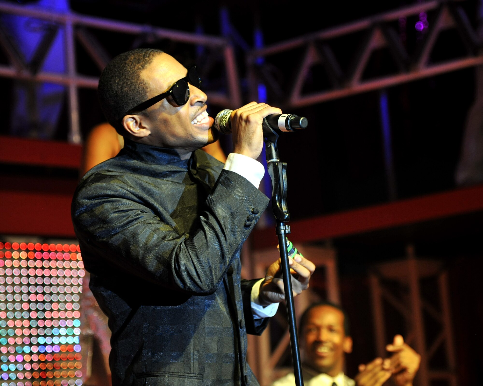 RAF MILDENHALL, England - Staff Sgt. Derek Speights, Tops in Blue vocalist, gives his version of Ray Charles during a performance at the North Side Fitness Center here Oct. 8, 2011. Founded in the 1950s, the group puts on more than 100 shows during their tour. This year’s tour covered popular American music including classics like Jerry Lee Lewis, Elvis Presley to more modern artists like Madonna and Maroon 5. (U.S. Air Force photo/Senior Airman Jerilyn Quintanilla)