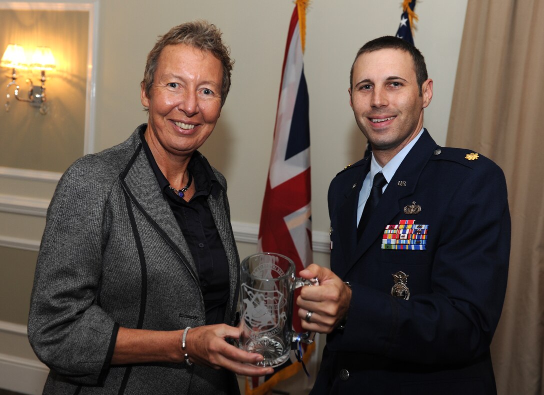 RAF ALCONBURY, United Kingdom - Julie Spence is welcomed by Maj. Erik Dutkiewicz as the honorary 423rd Security Forces Squadron commander during an induction ceremony here Oct. 7. (U.S. Air Force photo by Tech. Sgt. John Barton)