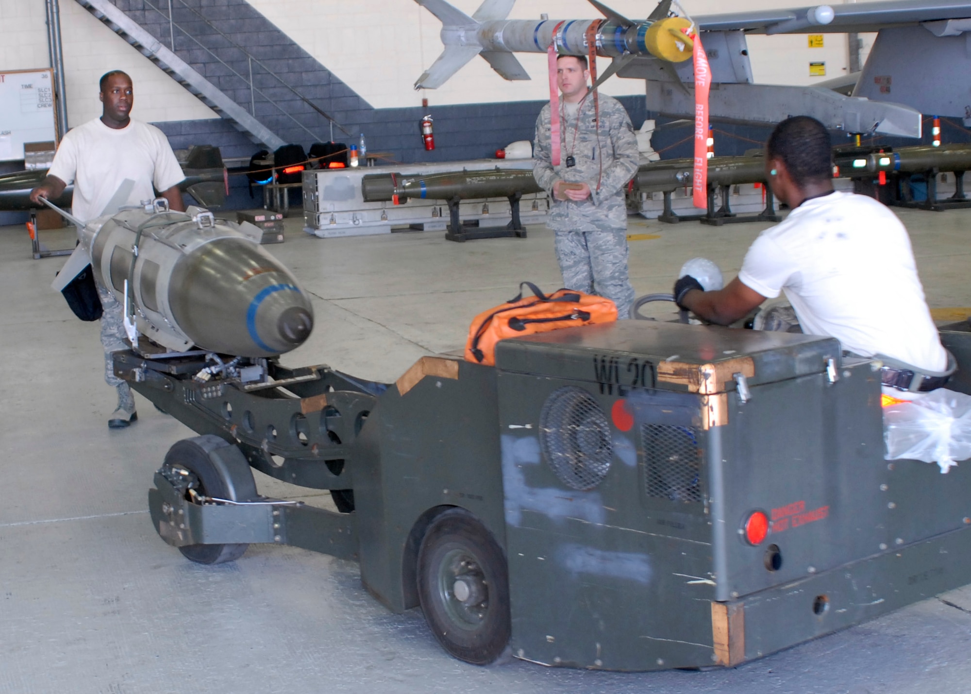 Staff Sgt. Chris Fleming (left) and Staff Sgt. Terry White, 36th Aircraft Maintenance Unit weapons loaders, transport a GBU-31 bomb to an F-16 during the 3rd Quarter Load Crew Competition Oct. 4. Crew 3 from the 25th AMU won the competition. (U.S. Air Force photo/Tech. Sgt. Eric Petosky)