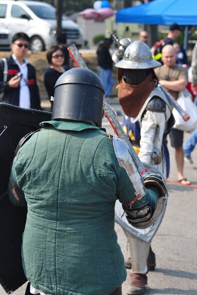 Members of the 51st Civil Engineer Squadron perform Oct. 8, 2011, during the 10th Annual “BBQ & Blues” event hosted by the 51st Force Support Squadron at the parking lot near the Officers Club. This day of free food and fun was filled with barbecued ribs and the sounds of music pounding away at the eardrums. Eighteen groups started their day at about 7 a.m. to compete to be crowned the team with the best ribs on base. (U.S. Air Force photo/Tech. Sgt. Chad Thompson)