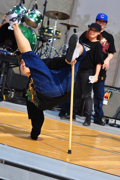 A break-dance team performs Oct. 8, 2011, during the 10th Annual “BBQ & Blues” event hosted by the 51st Force Support Squadron at the parking lot near the Officers Club. This day of free food and fun was filled with barbecued ribs and the sounds of music pounding away at the eardrums. Eighteen groups started their day at about 7 a.m. to compete to be crowned the team with the best ribs on base. (U.S. Air Force photo/Tech. Sgt. Chad Thompson)