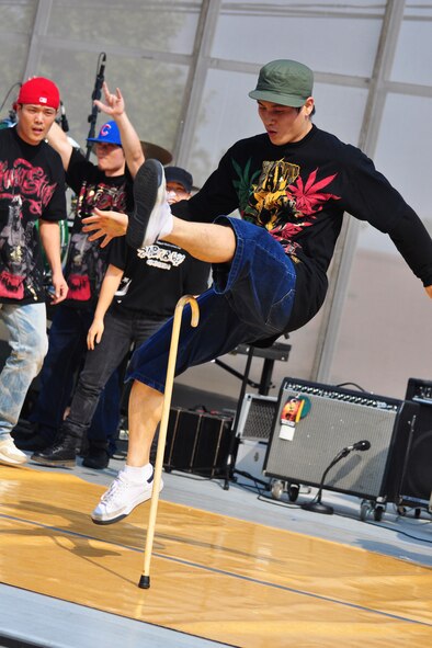 A break-dance team performs Oct. 8, 2011, during the 10th Annual “BBQ & Blues” event hosted by the 51st Force Support Squadron at the parking lot near the Officers Club. This day of free food and fun was filled with barbecued ribs and the sounds of music pounding away at the eardrums. Eighteen groups started their day at about 7 a.m. to compete to be crowned the team with the best ribs on base. (U.S. Air Force photo/Tech. Sgt. Chad Thompson)