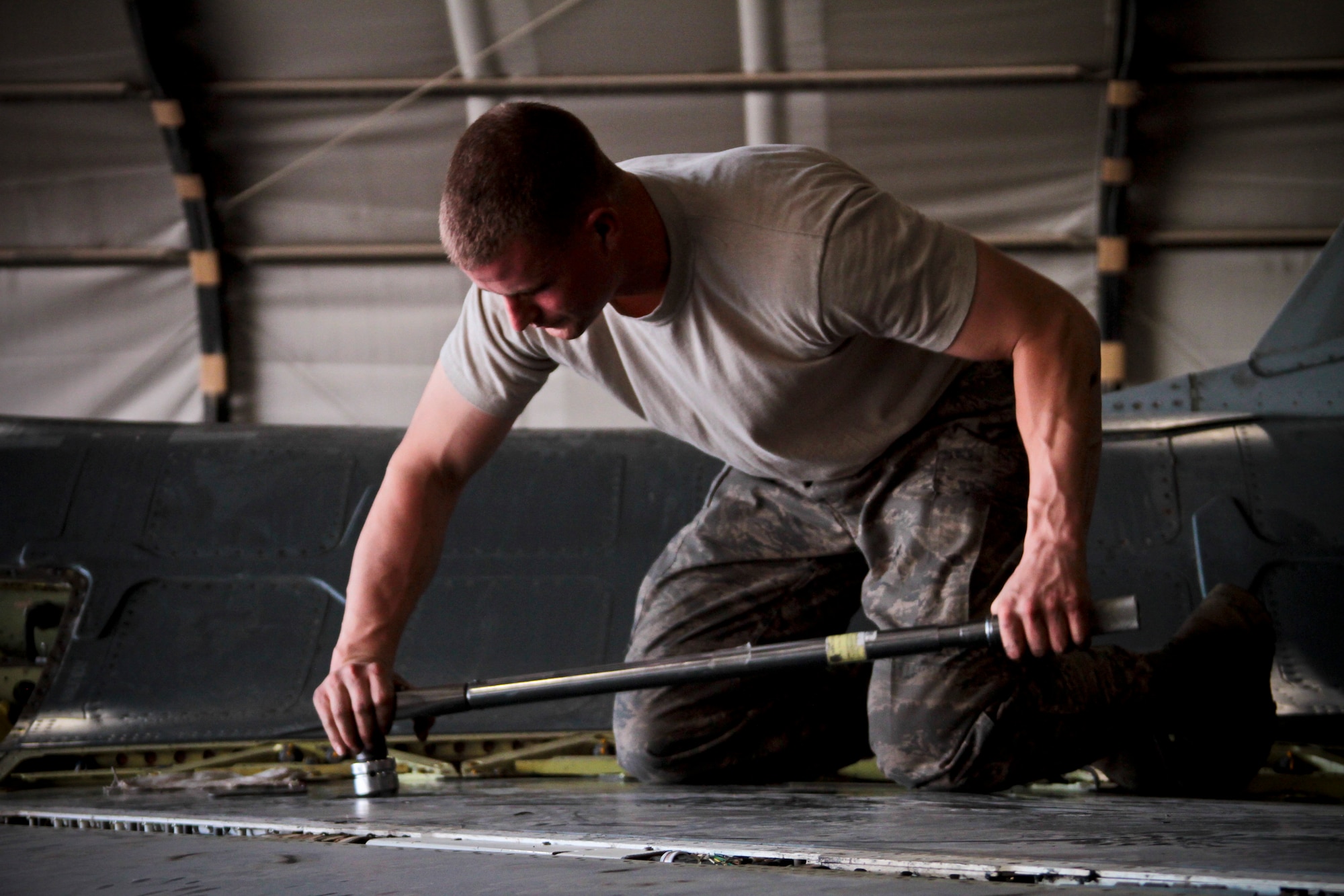 Airman 1st Class Adam Sexton, a 455th Expeditionary Aircraft Maintenance Squadron crew chief, removes the wing panel of an F-16C Fighting Falcon Oct. 4, 2011.  Sexton, a Cincinnati native, is deployed from Aviano Air Base, Italy.  (U.S. Air Force Photo/Tech. Sgt. Matt Hecht)