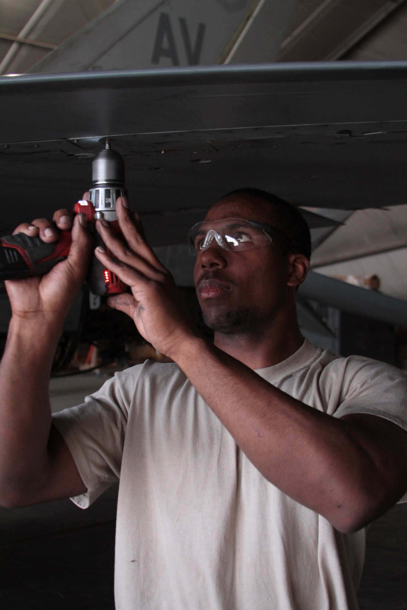 Staff Sgt. Teko Robinson, F-16 Phase Dock team member, installs a panel on the wing of an F-16C Fighting Falcon Oct. 4, 2011.  Robinson, who is a Colorado Springs, Colo., native, is deployed from Aviano Air Base, Italy.  (U.S. Air Force photo/Tech. Sgt. Matt Hecht)