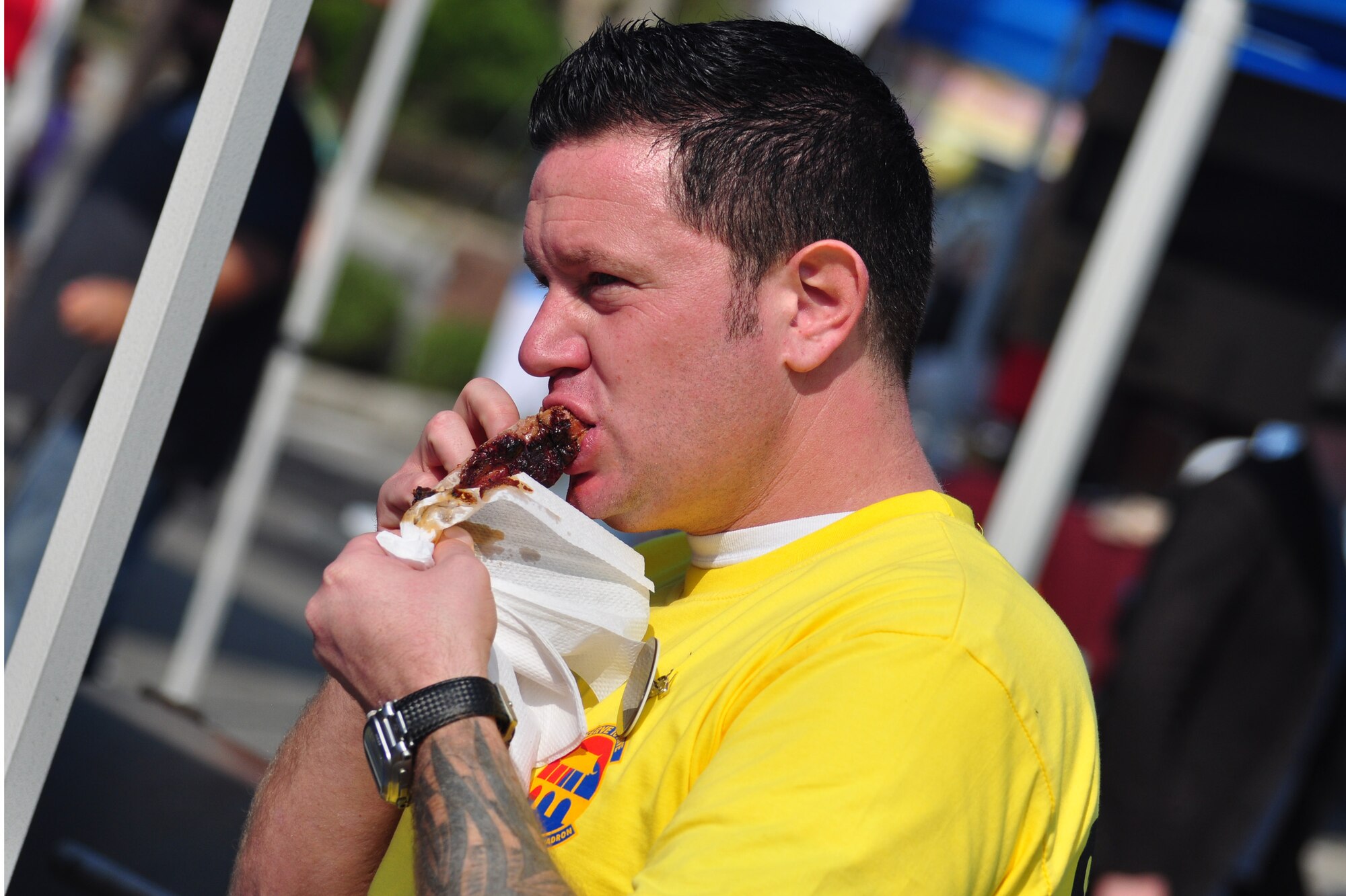 An attendee tries a rib Oct. 9, 2011, during the 10th Annual “BBQ & Blues” event hosted by the 51st Force Support Squadron at the parking lot near the Officers Club. This day of free food and fun was filled with barbecued ribs and the sounds of music pounding away at the eardrums. Eighteen groups started their day at about 7 a.m. to compete to be crowned the team with the best ribs on base. (U.S. Air Force photo/Tech. Sgt. Chad Thompson)