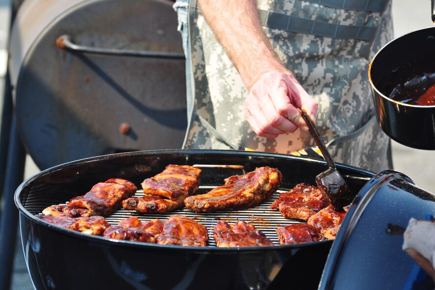 A competitor prepares his batch of ribs Oct. 9, 2011, during the 10th Annual “BBQ & Blues” event hosted by the 51st Force Support Squadron at the parking lot near the Officers Club. This day of free food and fun was filled with barbecued ribs and the sounds of music pounding away at the eardrums. Eighteen groups started their day at about 7 a.m. to compete to be crowned the team with the best ribs on base. (U.S. Air Force photo/Tech. Sgt. Chad Thompson)