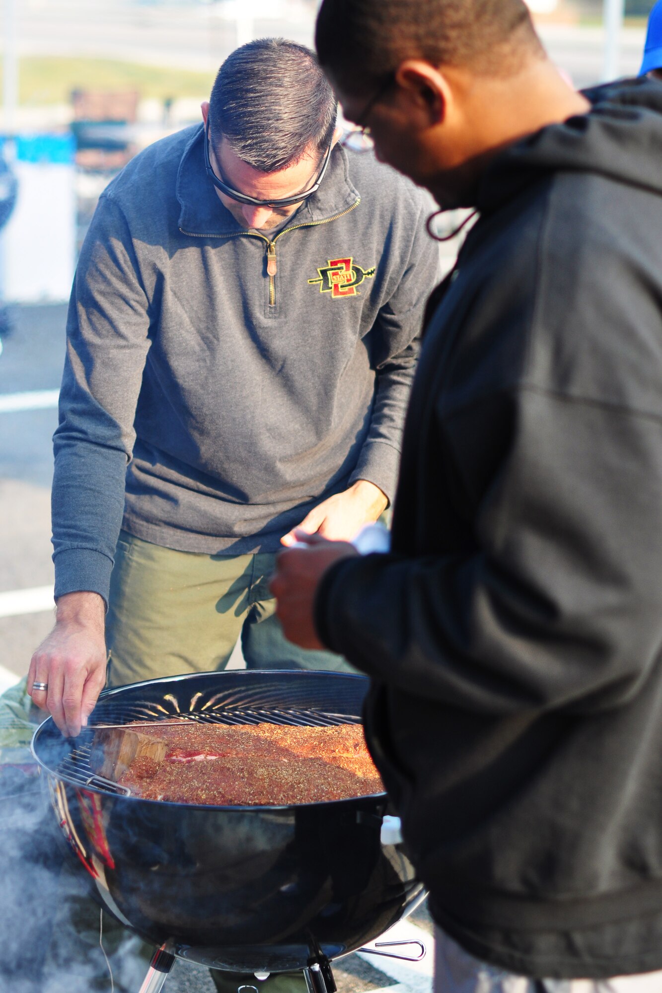 Lt. Col. Jeff Valenzia, 51st Operations Support Squadron Commander, prepares his batch of ribs Oct. 9, 2011, during the 10th Annual “BBQ & Blues” event hosted by the 51st Force Support Squadron at the parking lot near the Officers Club. This day of free food and fun was filled with barbecued ribs and the sounds of music pounding away at the eardrums. Eighteen groups started their day at about 7 a.m. to compete to be crowned the team with the best ribs on base. (U.S. Air Force photo/Tech. Sgt. Chad Thompson)