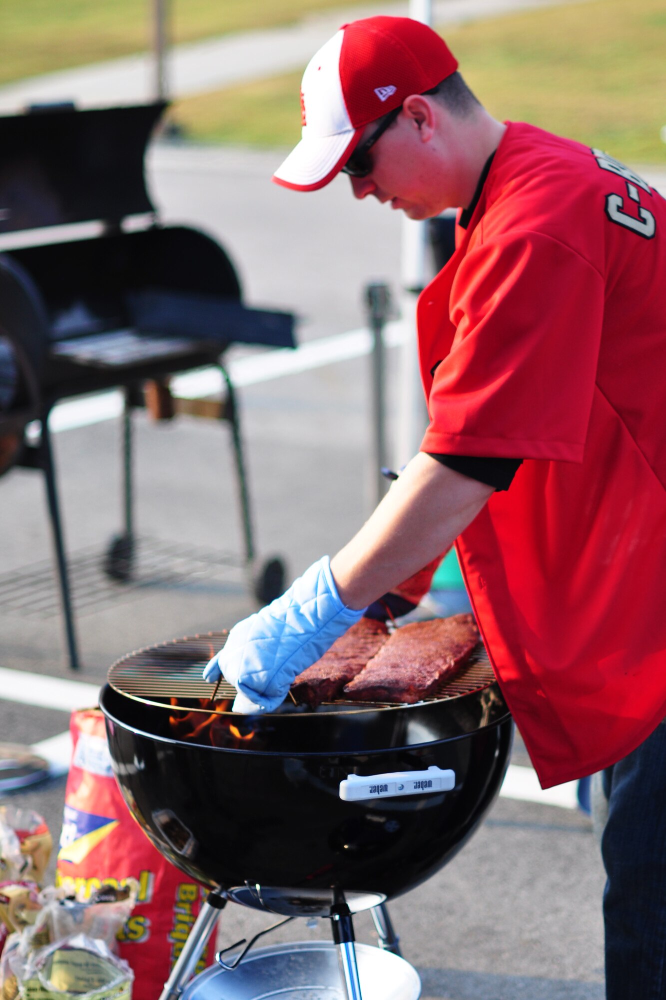 Staff Sgt. Doran Pribilski, 694th Intelligence Surveillance and Reconnaissance Squadron, prepares his batch of ribs Oct. 9, 2011, during the 10th Annual “BBQ & Blues” event hosted by the 51st Force Support Squadron at the parking lot near the Officers Club. This day of free food and fun was filled with barbecued ribs and the sounds of music pounding away at the eardrums. Eighteen groups started their day at about 7 a.m. to compete to be crowned the team with the best ribs on base. (U.S. Air Force photo/Tech. Sgt. Chad Thompson)