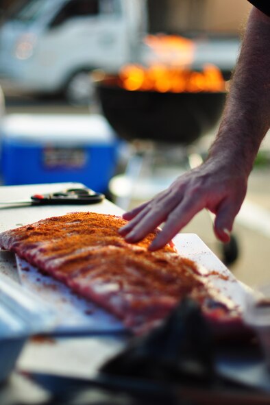 A competitor prepares his batch of ribs Oct. 9, 2011, during the 10th Annual “BBQ & Blues” event hosted by the 51st Force Support Squadron at the parking lot near the Officers Club. This day of free food and fun was filled with barbecued ribs and the sounds of music pounding away at the eardrums. Eighteen groups started their day at about 7 a.m. to compete to be crowned the team with the best ribs on base. (U.S. Air Force photo/Tech. Sgt. Chad Thompson)