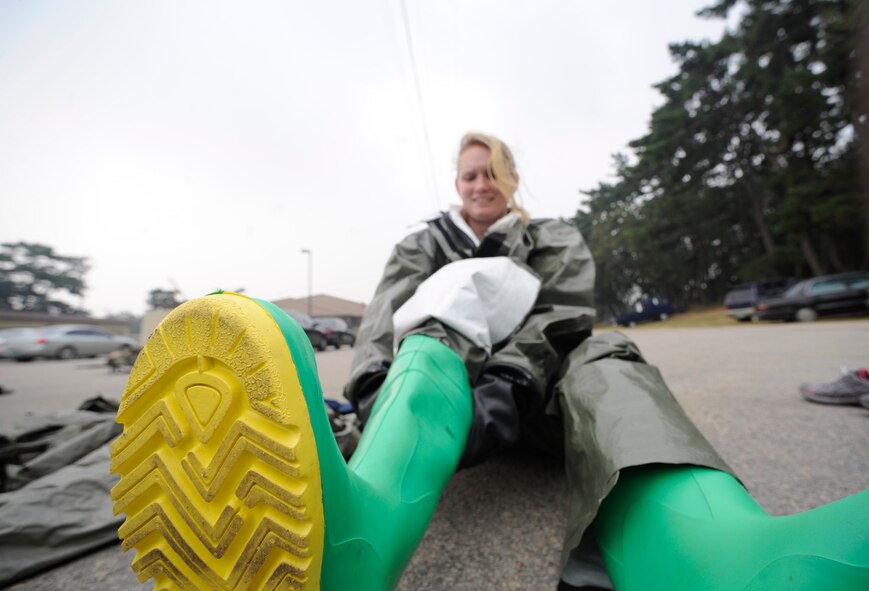 Staff Sgt. Bernice Rose, 8th Medical Group health administration technician gets into her Disposable Toxic Agent Protective (DTAP) suit in preparation of receiving contaminated patients in a simulated contaminated environment exercise at Kunsan Air Base, Republic of Korea, Oct. 6, 2011. The team spent two days, Oct. 5 and 6, 2011, undergoing training and instruction on chemical agents and proper decontamination procedures. (U.S. Air Force photo by Staff Sgt. Rasheen A. Douglas/Released)