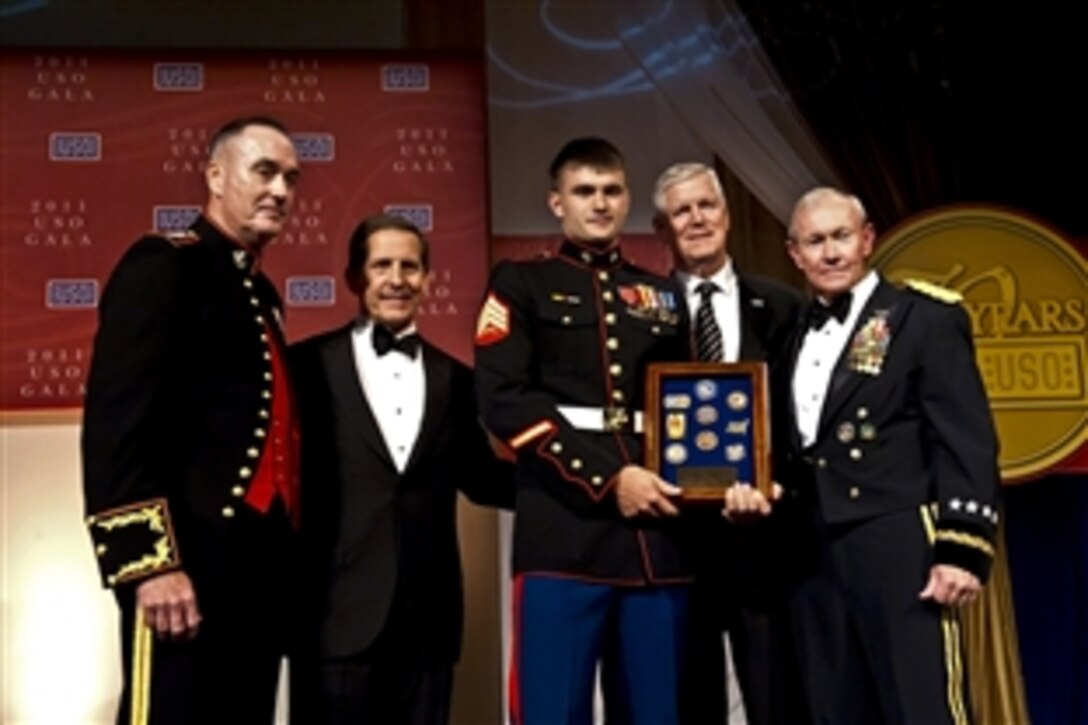 Marine Corps Sgt. Lucas Chaffins, center, receives the USO Marine of the Year Award from Marine Corps Gen. Joseph F. Dunford Jr., assistant commandant of the Marine Corps; USO President Sloan D. Gibson; retired Air Force Gen. Richard B. Myers, former chairman of the Joint Chiefs of Staff; and Army Gen. Martin E. Dempsey, chairman of the Joint Chiefs of Staff, during the 2011 USO Gala in Washington, D.C., Oct. 6, 2011.