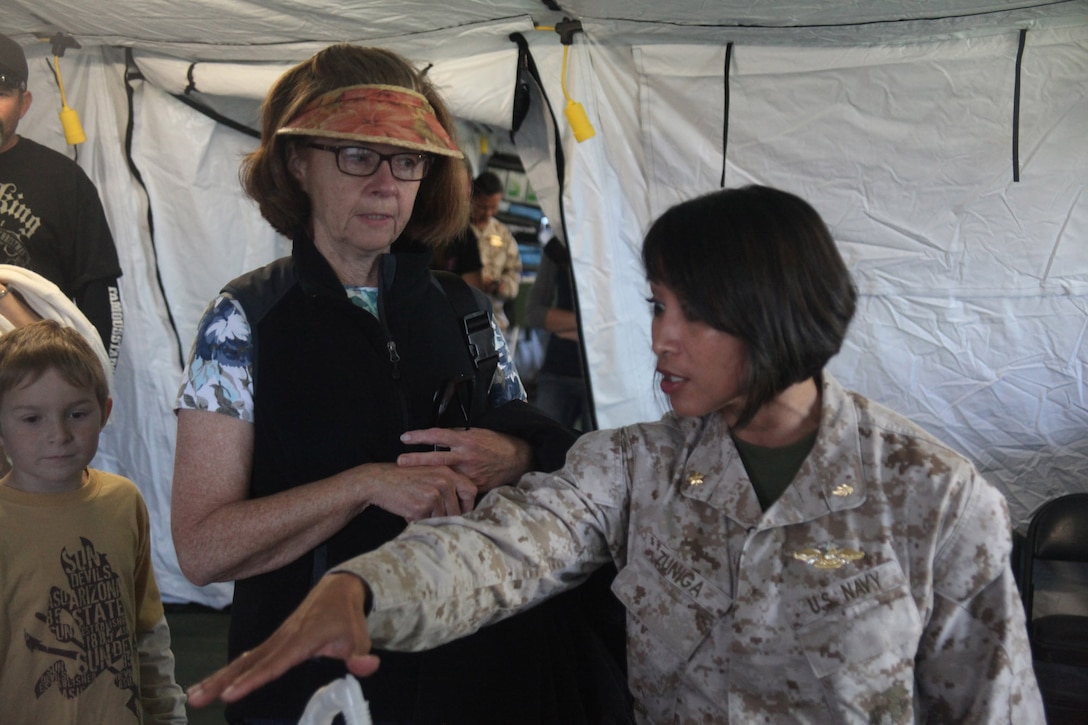 Lt. Cmdr. Georgina Zunega, the deputy group surgeon and emergency room nurse with 1st Marine Logistics Group explains the usage of medical equipment to civilians, Oct. 8, 2011. Zunega, a native of Fallbrook, Calif., said her main goal of the day was to help build relations with San Franciscans and explain the equipment they use for humanitarian aid and disaster response. (Marine photo by Lance Cpl. Timothy J. Lenzo)