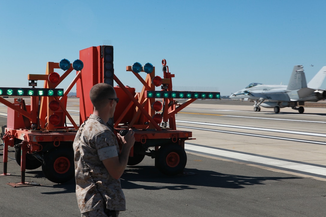 Sgt. Shawn Arnold, an aircraft recovery crew leader with Marine Wing Support Squadron 473 and a San Diego native, reports that the Improved Fresnel Lens Optical Landing System is ready aboard Marine Corps Air Station Miramar, Calif., Oct. 11. The IFLOLS is designed to give glidepath information to pilots to help them land.