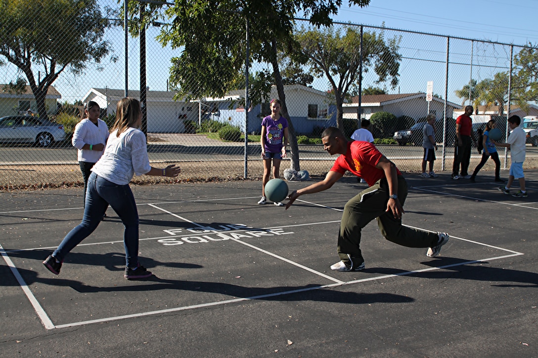 Staff Sgt. Owein M. Ramirez, a drill instructor with 1st Recruit Training Battalion, Alpha Company, plays four square with students during a visit to Holmes Elementary School as part of the Partnership in Education Program Tuesday. The PIE program consists of Marine volunteers visiting the school every other Tuesday to participate in physical educations classes in an effort to provide the students with positive role models.