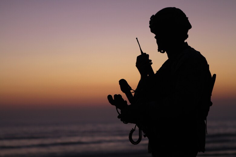 A Marine with Company L uses a radio here Oct. 11 during a training assault with the 11th Marine Expeditionary Unit. The company is one of three rifle companies with Battalion Landing Team 3/1, the ground-combat element for the unit. The unit embarked USS Makin Island, USS New Orleans and USS Pearl Harbor in Spet. 28 for its final exercise before deploying in November. ::r::::n::