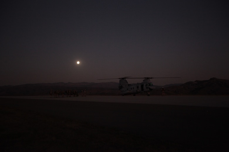 Marines and sailors with Weapons Platoon load onto a CH-46E Sea Knight helicopter with Marine Medium Helicopter Squadron 268 (Reinforced) here Oct. 11 before participating in a nighttime training raid with Company K. The platoon provided casualty-evacuation capabilities and reinforcements for the company during the exercise. Company K is one of three rifle companies with Battalion Landing Team 3/1, the ground-combat element for the 11th Marine Expeditionary Unit. The unit embarked USS Makin Island, USS New Orleans and USS Pearl Harbor Sept. 28 for a final exercise before deploying in November.