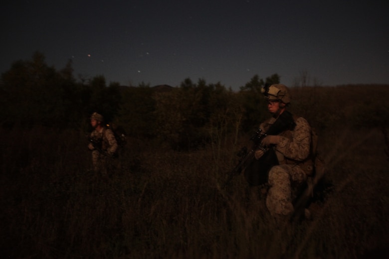 Lance Cpl. Jacob R. Obrienflashc, right, and Lance Cpl. Troy R. Townsend halt here Oct. 11 while patrolling during a nighttime training raid with Company K. The rifle company is one of three with Battalion Landing Team 3/1, the ground-combat element for the 11th Marine Expeditionary Unit. The unit embarked USS Makin Island, USS New Orleans and USS Pearl Harbor Sept. 28 for a final exercise before deploying in November. Obrienflashc, 19, a machine gunner, hails from Kewaskum, Wisc. Townsend, 21, and infantryman, hails from Kilgore, Texas.