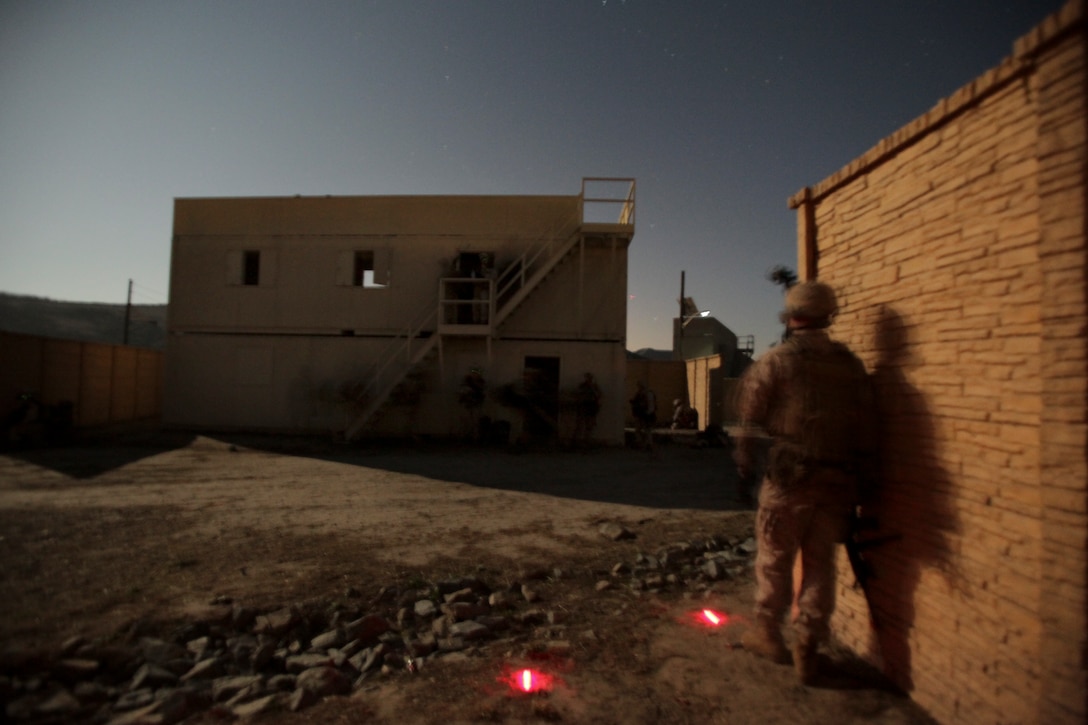 Marines and sailors with Company K conduct a nighttime training raid here Oct. 11 during an amphibious assault exercise with the 11th Marine Expeditionary Unit. Company K is one of three rifle companies with Battalion Landing Team 3/1, the ground-combat element for the unit. The unit embarked USS Makin Island, USS New Orleans and USS Pearl Harbor Sept. 28 for a final exercise before deploying in November.