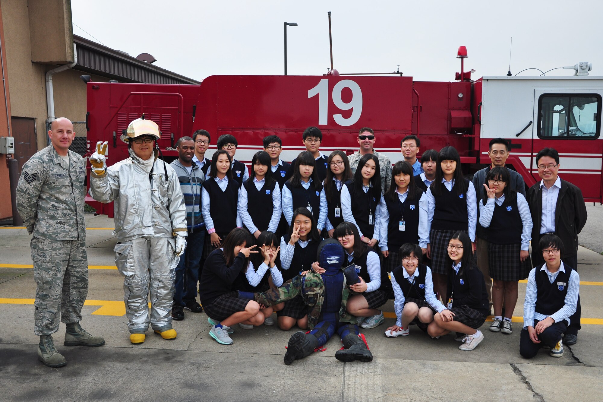 Students pose for a group picture after a visit to the Osan Fire Department Oct. 12, 2011. As a part of Fire Prevention Week, 21 students from a local Korean middle school toured the Osan Fire Department and got to see firsthand how a firefighter lives day to day. The students got to see several tools of the trade, learned about what a firefighter’s day is like and got a fire truck and ladder truck demonstration. Fire Prevention Week is the longest running public health and safety observance on record. (U.S. Air Force photo/Tech. Sgt. Chad Thompson)