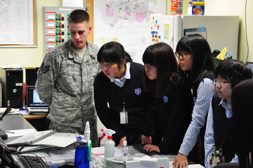 Staff Sgt. Zachary Weneck, 51st Civil Engineer Squadron firefighter, shows some Korean middle school students the base fire control system during a visit to the Osan Fire Department Oct. 12, 2011. As a part of Fire Prevention Week, 21 students from a local Korean middle school toured the Osan Fire Department and got to see firsthand how a firefighter lives day to day. The students got to see several tools of the trade, learned about what a firefighter’s day is like and got a fire truck and ladder truck demonstration. Fire Prevention Week is the longest running public health and safety observance on record. (U.S. Air Force photo/Tech. Sgt. Chad Thompson)