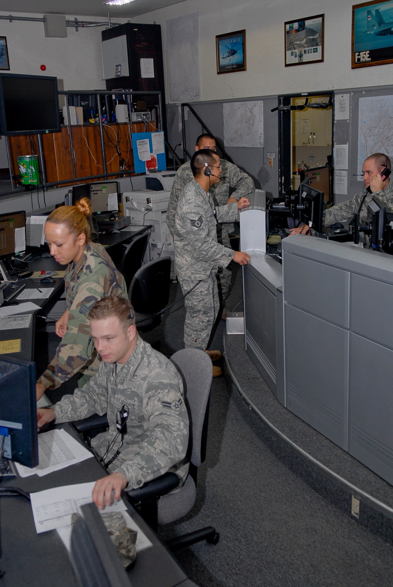 Members of the maintenance operations center track the current flying status for the 67th Fighter Squadron on Kadena Air Base, Japan, Oct. 12, 2011. The MOC is part of the 18th Maintenance Operations Squadron which is responsible for administration, analysis, training management, and programs and resources necessary to support the 18th Maintenance Group production efforts. (U.S. Air Force photo/Airman 1st Class Tara A. Williamson)